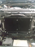 Wicked Wrench Motorsports dual transmission and power steering cooler bracket mounted on a Jeep Wrangler JK front clip with grille removed