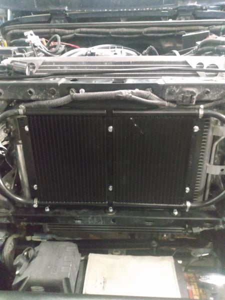 Wicked Wrench Motorsports dual transmission and power steering cooler bracket mounted on a Jeep Wrangler JK front clip with grille removed
