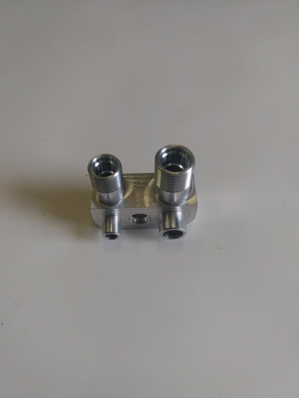 Wicked Wrench Motorsports custom billet Gen V AC adapter manifold block top view looking directly into the minus eight AN and minus ten AN machined ports