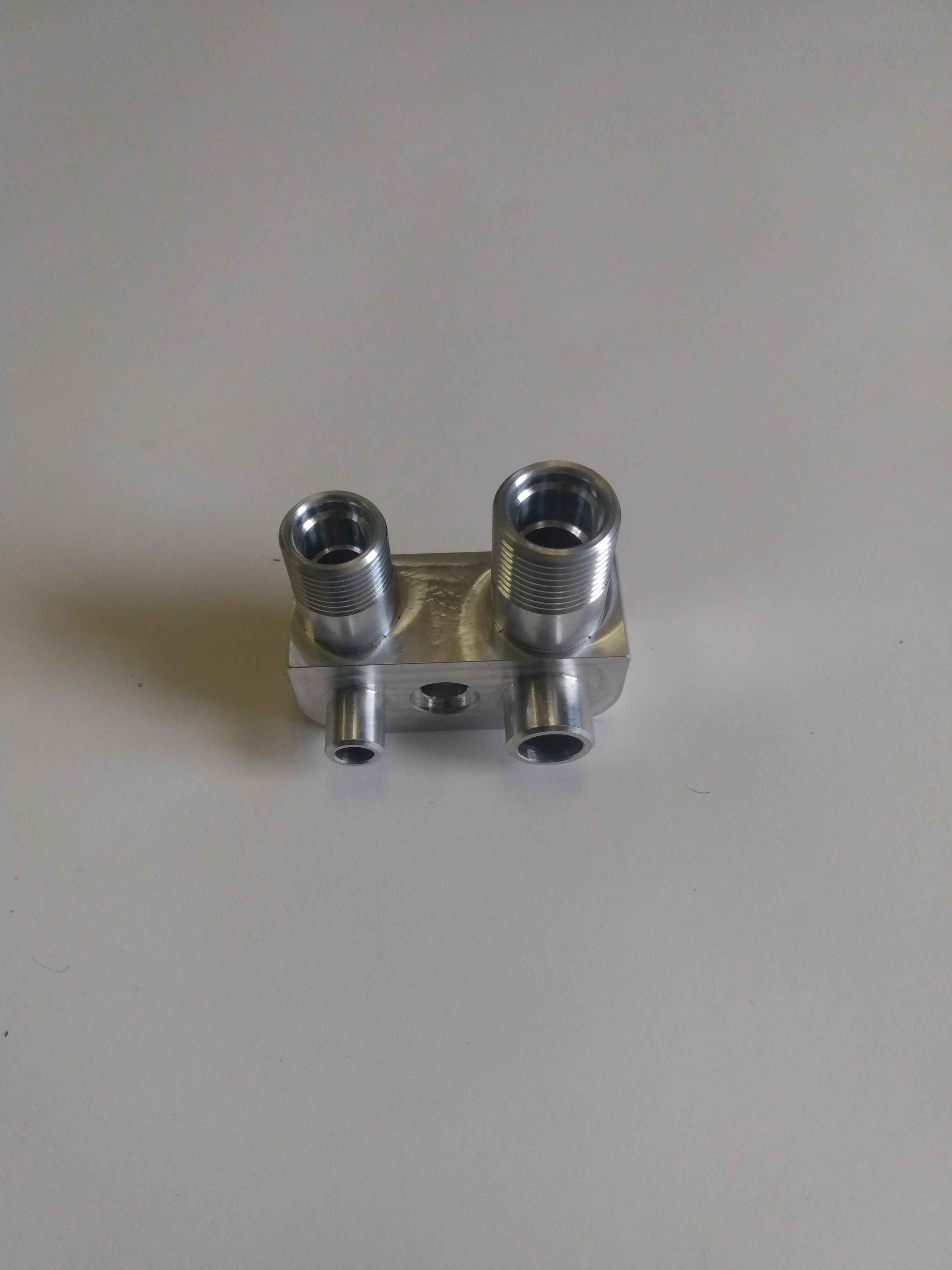 Wicked Wrench Motorsports custom billet Gen V AC adapter manifold block top view looking directly into the minus eight AN and minus ten AN machined ports